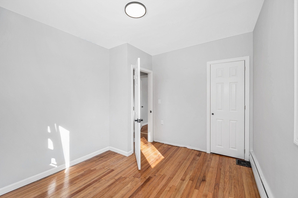 52 Elm Street Haverhill, MA 01830 - Photo 23 of 40 a view of an empty room with wooden floor
