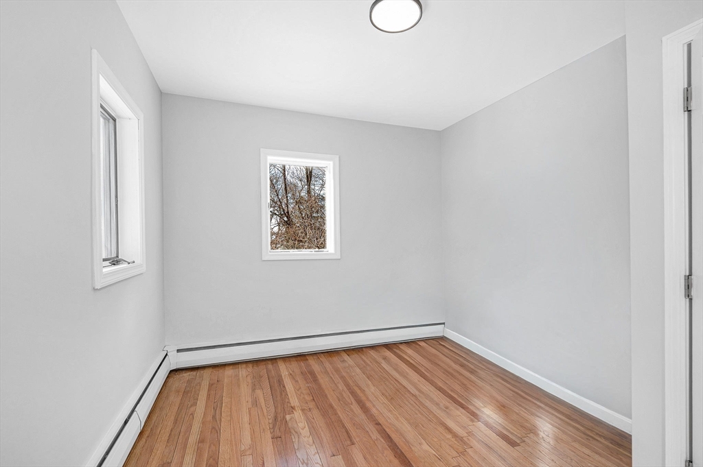 52 Elm Street Haverhill, MA 01830 - Photo 24 of 40 a view of room with window and wooden floor