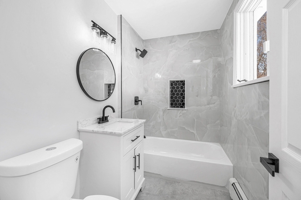 52 Elm Street Haverhill, MA 01830 - Photo 25 of 40 a bathroom with a sink a toilet and a bathtub