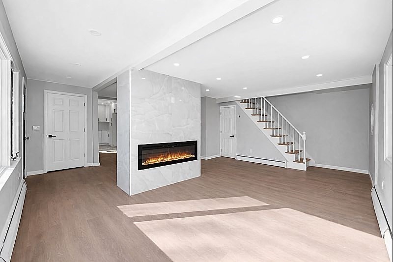 52 Elm Street Haverhill, MA 01830 - Photo 3 of 40 an empty room with windows and fireplace