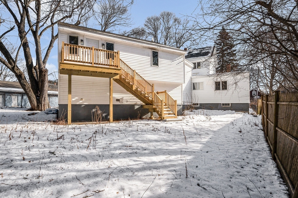 52 Elm Street Haverhill, MA 01830 - Photo 35 of 40 a front view of a house with a yard covered with snow