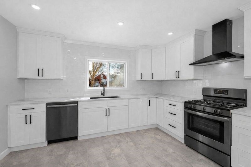 52 Elm Street Haverhill, MA 01830 - Photo 6 of 40 a kitchen with stainless steel appliances a stove sink and cabinets