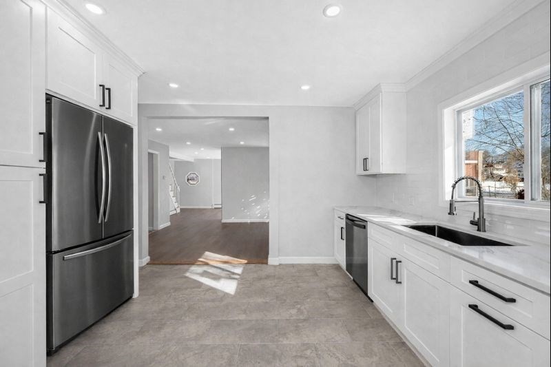 52 Elm Street Haverhill, MA 01830 - Photo 7 of 40 a kitchen with stainless steel appliances granite countertop a refrigerator and a sink