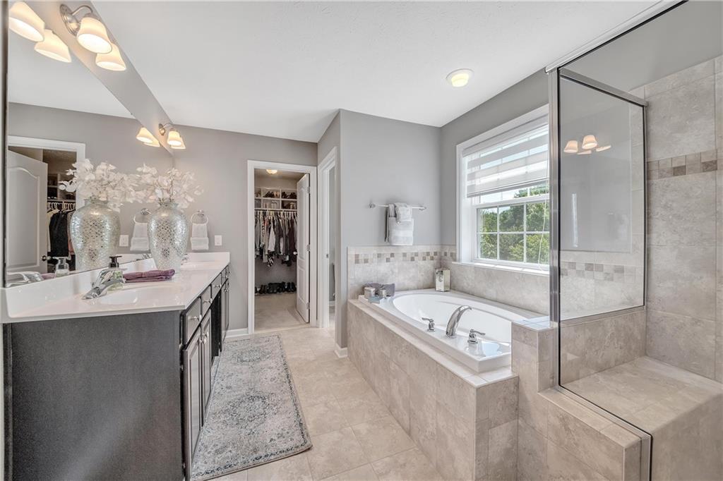 896 Ashley Road Gibsonia, PA 15044 - Photo 12 of 25 a large bathroom with a double vanity sink mirror and bathtub