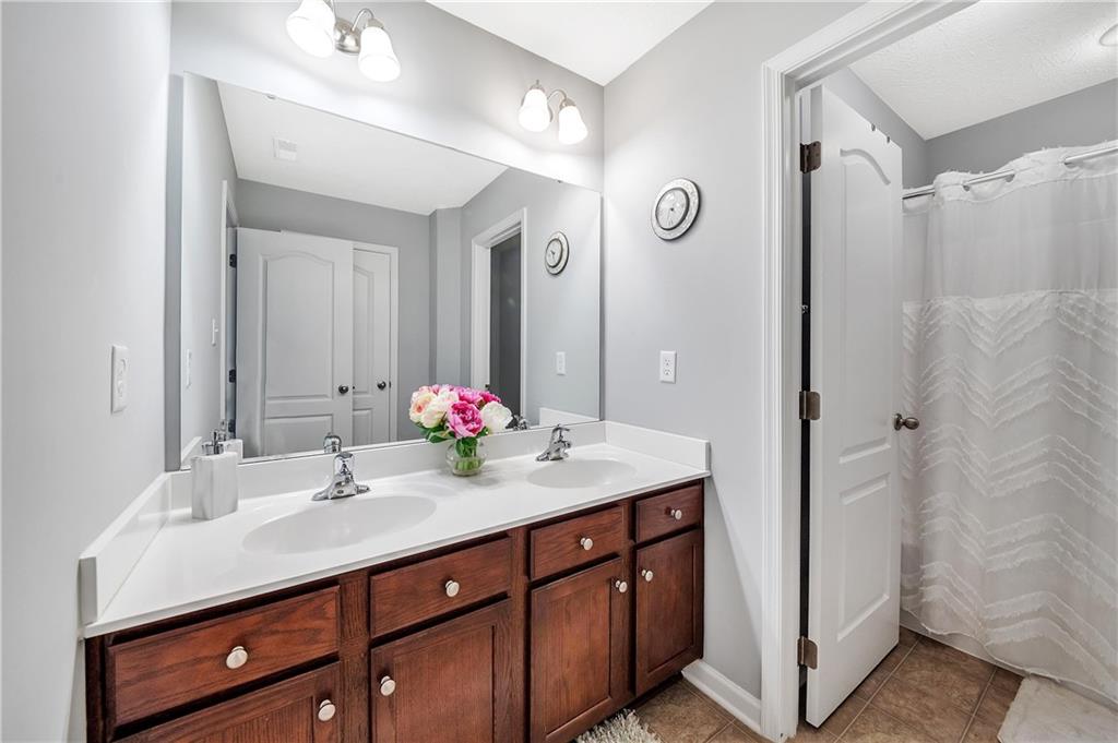 896 Ashley Road Gibsonia, PA 15044 - Photo 15 of 25 a bathroom with a double vanity sink and a mirror