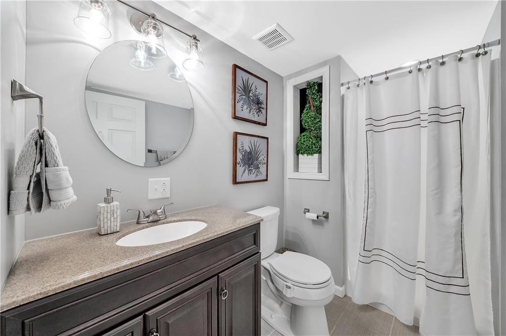 896 Ashley Road Gibsonia, PA 15044 - Photo 20 of 25 a bathroom with a granite countertop sink toilet and a mirror