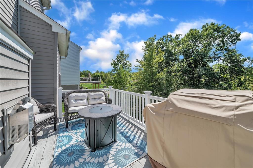 896 Ashley Road Gibsonia, PA 15044 - Photo 5 of 25 a view of a patio with table and chairs with wooden floor and fence