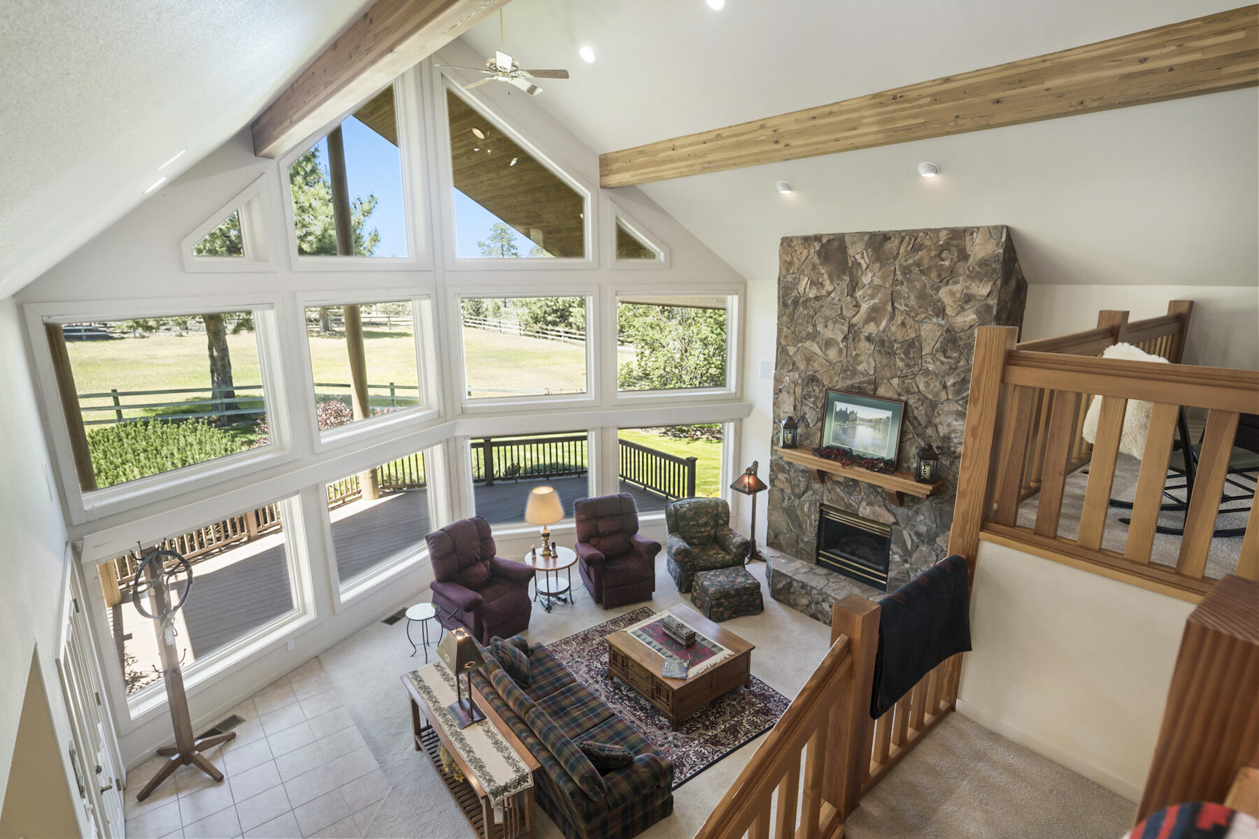 60696 Tekampe Road Bend, OR 97702 - Photo 25 of 61 a living room with furniture and a floor to ceiling window