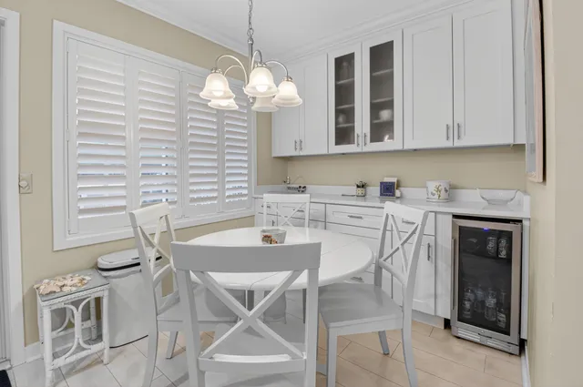 a view of a dining room cabinets and chandelier