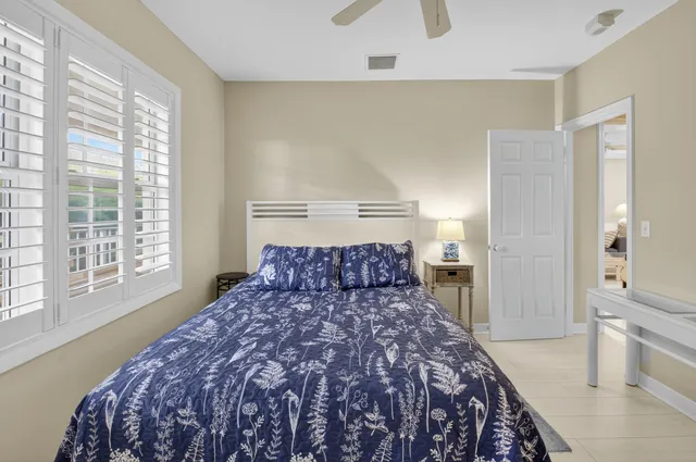 a large bed sitting in a bedroom next to a window and a larger closet