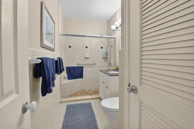 a bathroom with a toilet and a shower