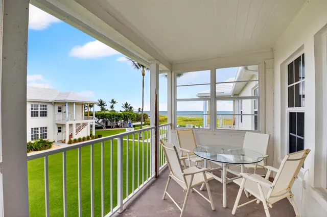 a view of a balcony dining table and chairs