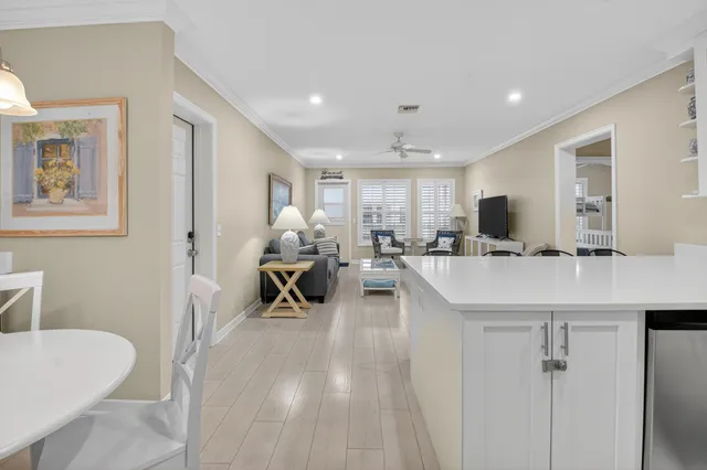 a view of a kitchen with kitchen island stainless steel appliances refrigerator stove a sink dishwasher with a dining table and chairs