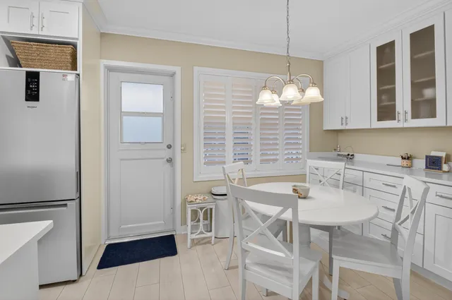 a kitchen with a table chairs and entryway