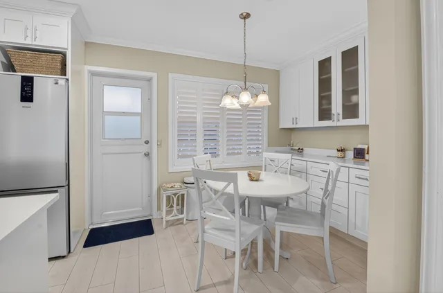 a view of a dining room with furniture and chandelier