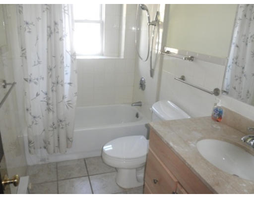 53 Harvard Street Extension Natick, MA 01760 - Photo 5 of 11 a bathroom with a granite countertop sink a toilet and shower