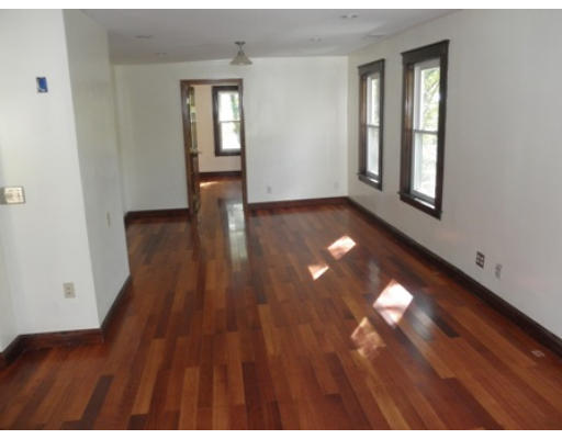 53 Harvard Street Extension Natick, MA 01760 - Photo 8 of 11 a view of an empty room with wooden floor and a window