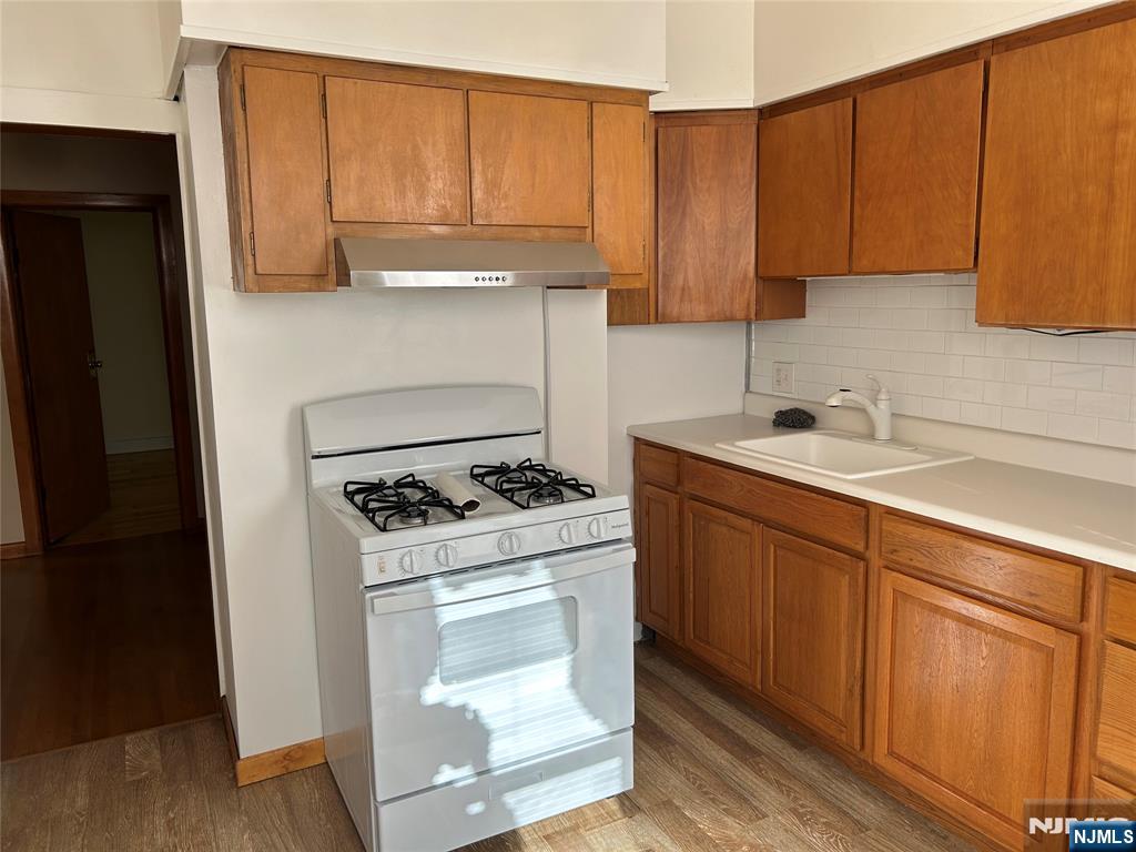 192 Kearny Avenue, Unit 2 Kearny, NJ 07032 - Photo 11 of 16 a kitchen with a sink stove and cabinets