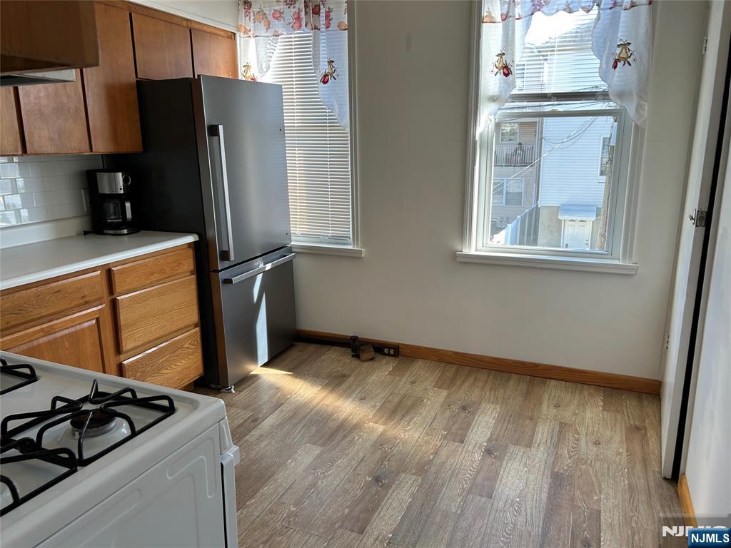 192 Kearny Avenue, Unit 2 Kearny, NJ 07032 - Photo 8 of 16 a view of a kitchen with wooden floor and electronic appliances