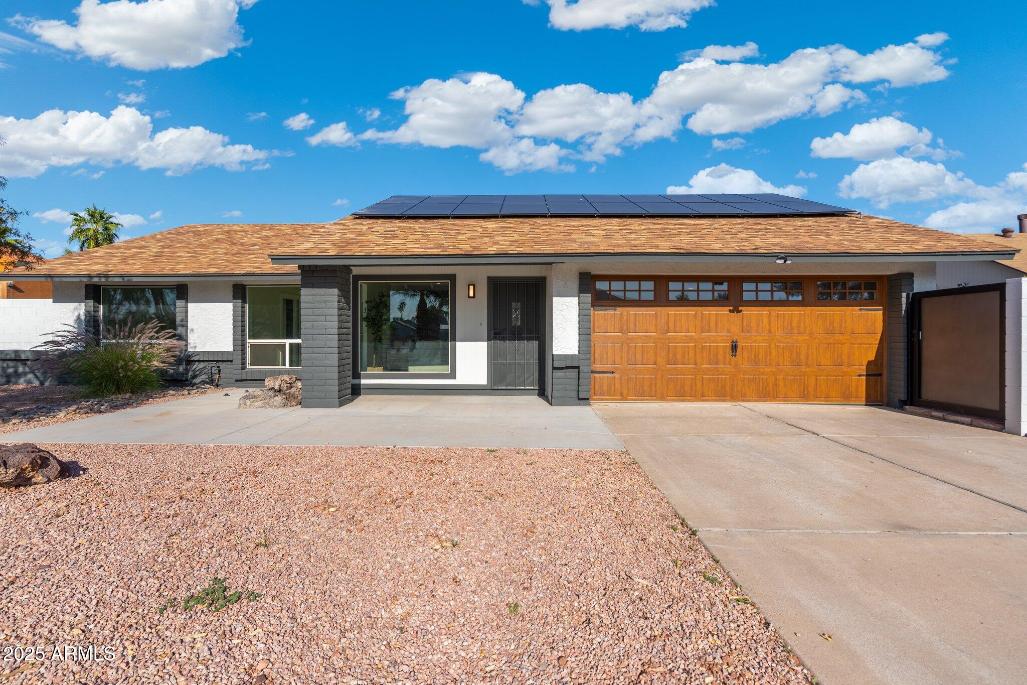 1721 North Apache Drive Chandler, AZ 85224 - Photo 1 of 22 a front view of a house with a garden