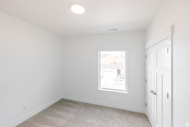 675 West 4500th South, Unit P302 Mapleton, UT 84664 - Photo 7 of 16 Neutral-toned carpeting complements the white walls and trim throughout this room