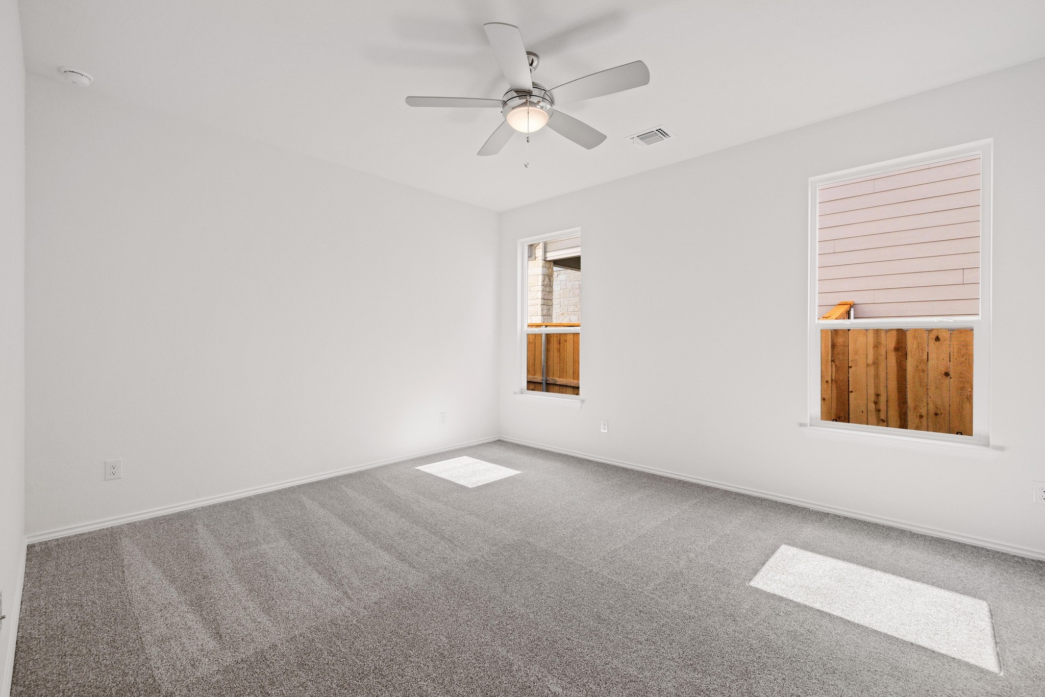 260 Feathers Street Jarrell, TX 76537 - Photo 16 of 34 an empty room with windows and fan