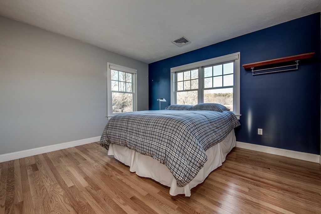 311 Still River Road Harvard, MA 01451 - Photo 21 of 27 a room with a bed and wooden floor