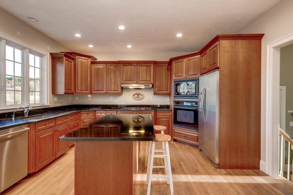311 Still River Road Harvard, MA 01451 - Photo 5 of 27 a kitchen with stainless steel appliances granite countertop a refrigerator and a stove top oven