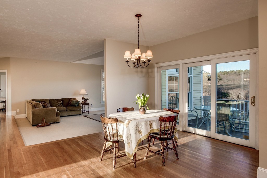 311 Still River Road Harvard, MA 01451 - Photo 8 of 27 a dining room with furniture a chandelier and wooden floor