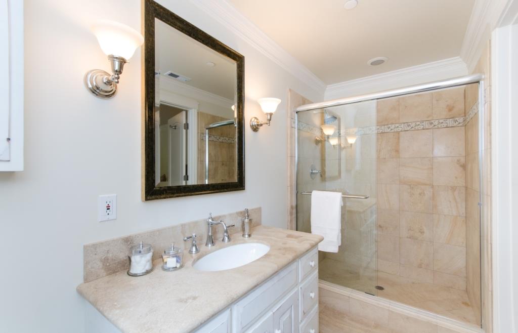 26990 Taaffe Road Los Altos Hills, CA 94022 - Photo 14 of 25 a bathroom with a granite countertop sink mirror and a shower