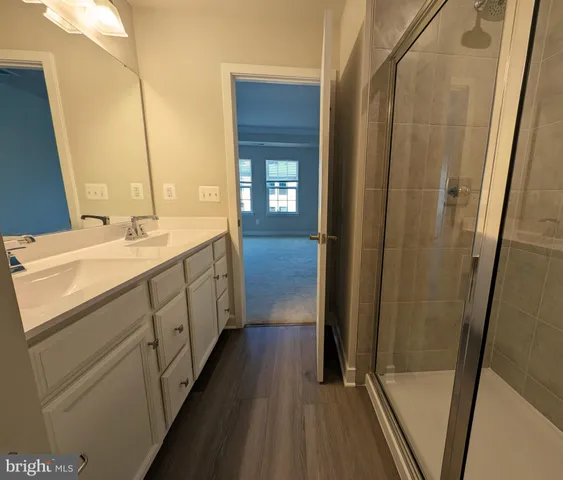 a bathroom with a double vanity sink and a mirror