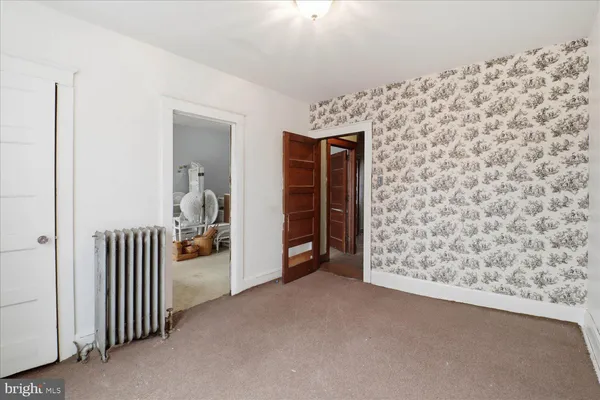 a view of a livingroom with wooden floor and entryway
