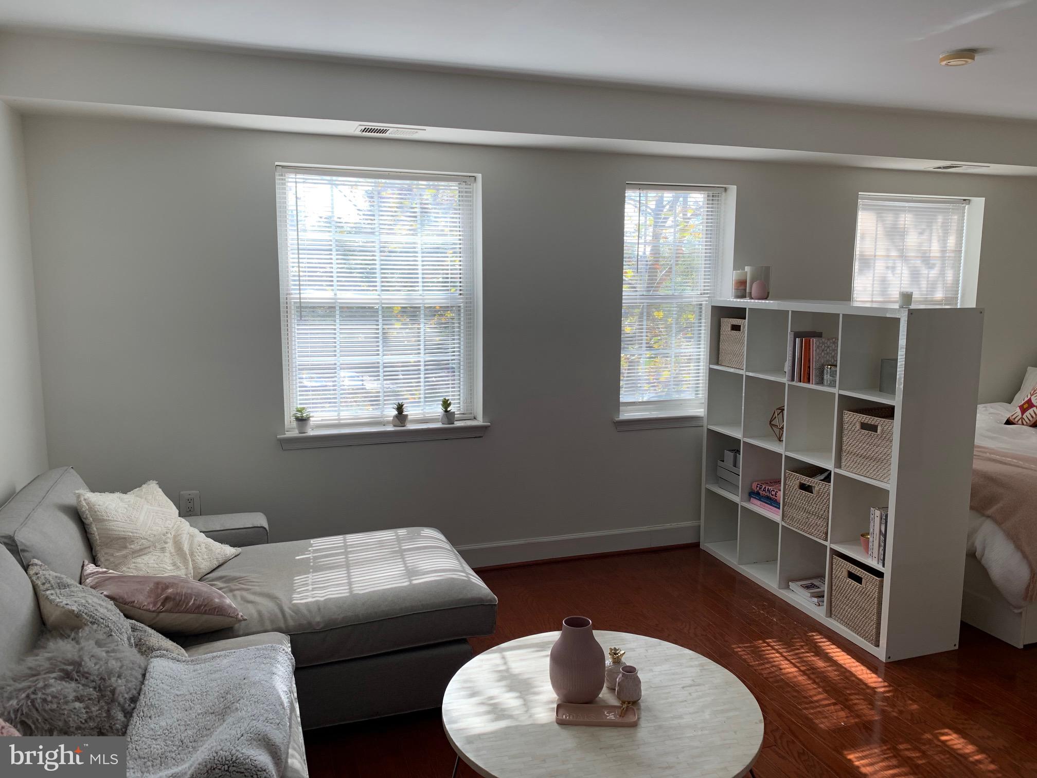 3609 38th Street Northwest, Unit 303 Washington, DC 20016 - Photo 8 of 11 a living room with furniture and a window