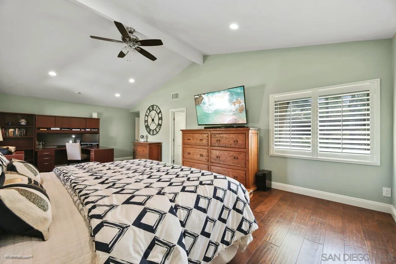 1540 Avenida De Las Lilas Encinitas, CA 92024 - Photo 26 of 39 a bedroom with a bed and a flat screen tv