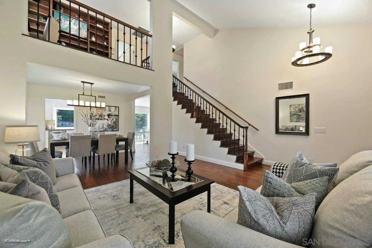 1540 Avenida De Las Lilas Encinitas, CA 92024 - Photo 8 of 39 a living room with furniture a dining table and a chandelier