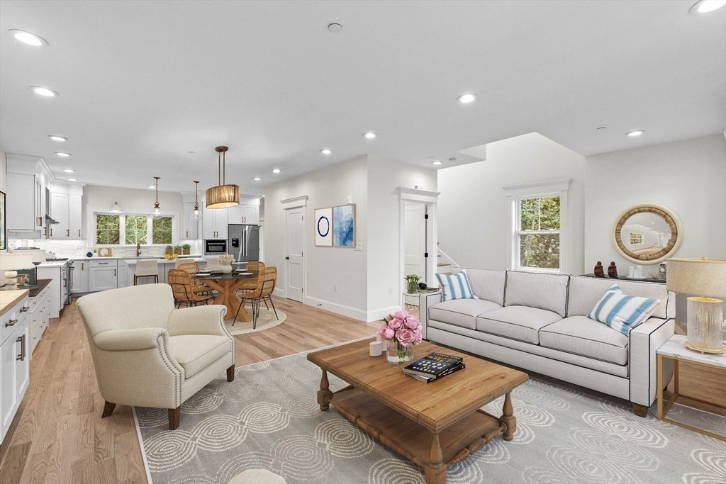 a living room with furniture kitchen view and a table