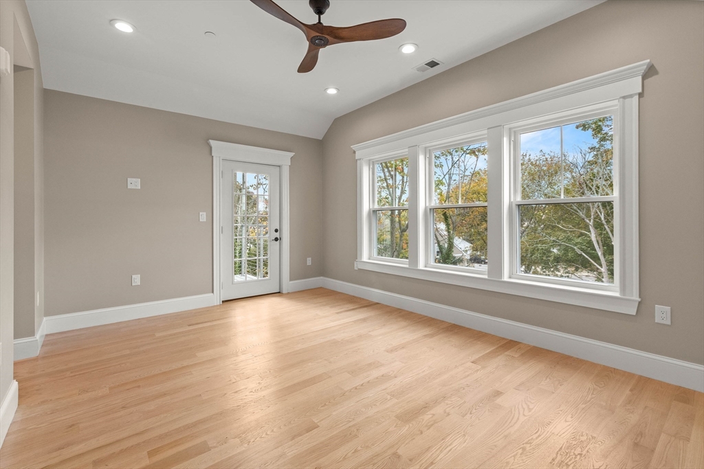 116 East Main Street, Unit 8 Gloucester, MA 01930 - Photo 14 of 31 a view of an empty room with a window and wooden floor