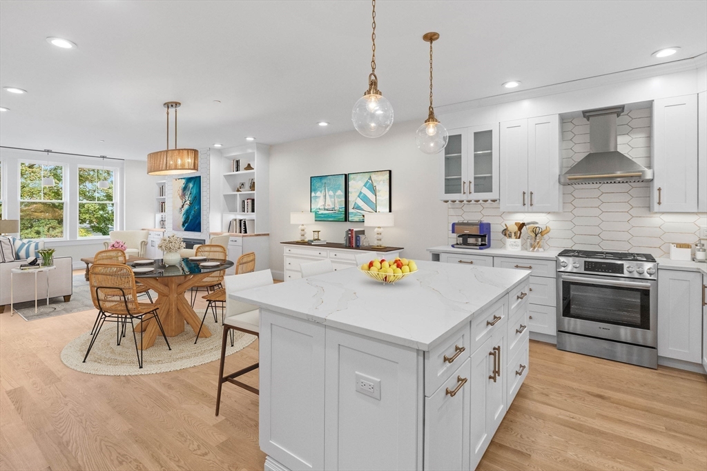 116 East Main Street, Unit 8 Gloucester, MA 01930 - Photo 2 of 31 a kitchen that has a lot of stainless steel appliances