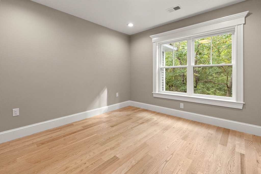 116 East Main Street, Unit 8 Gloucester, MA 01930 - Photo 21 of 31 a view of an empty room with wooden floor and a window