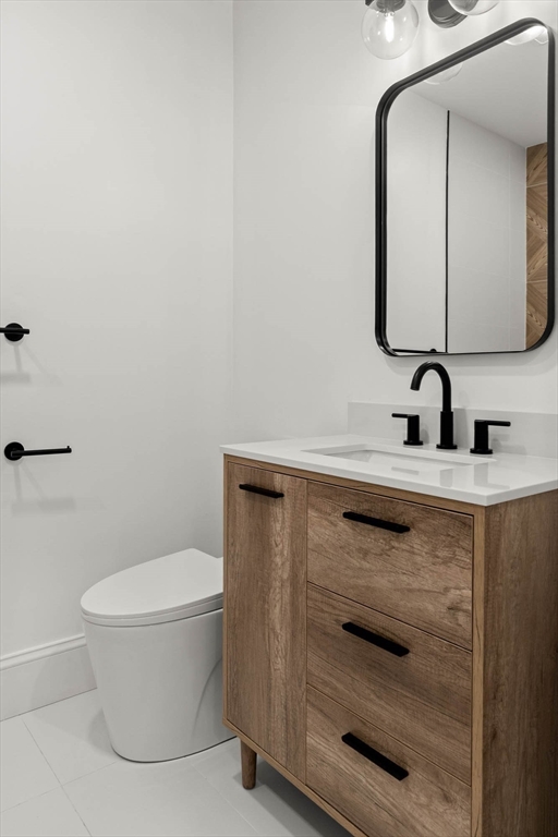 116 East Main Street, Unit 8 Gloucester, MA 01930 - Photo 22 of 31 a bathroom with a toilet sink and mirror
