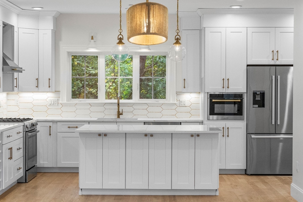 116 East Main Street, Unit 8 Gloucester, MA 01930 - Photo 3 of 31 a kitchen with stainless steel appliances granite countertop a stove a refrigerator and a sink
