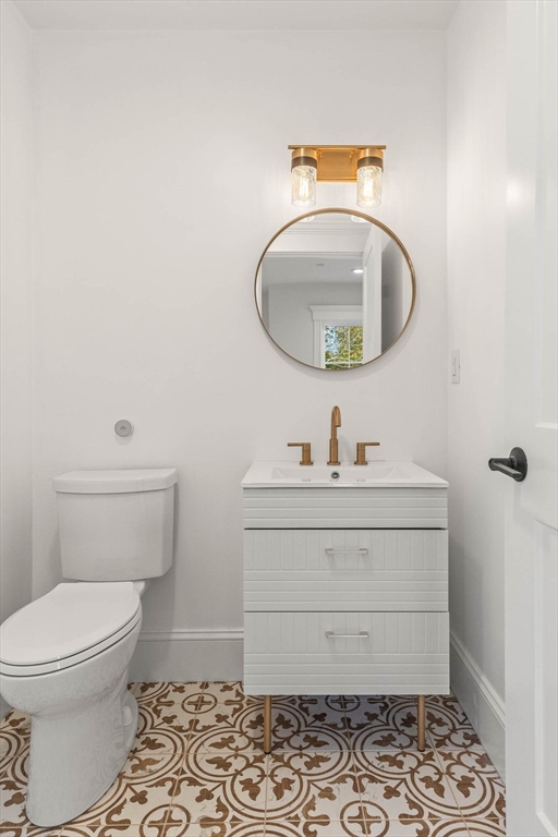 116 East Main Street, Unit 8 Gloucester, MA 01930 - Photo 8 of 31 a bathroom with a sink toilet and mirror