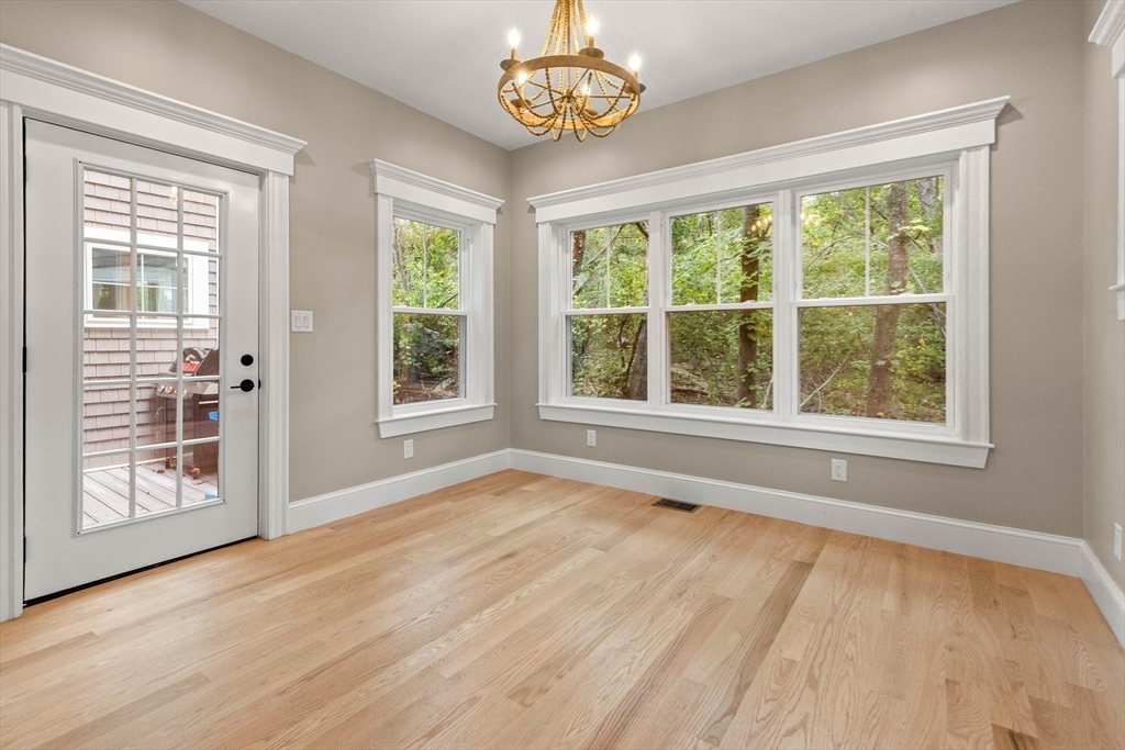 116 East Main Street, Unit 8 Gloucester, MA 01930 - Photo 10 of 31 a view of an empty room with a window and wooden floor