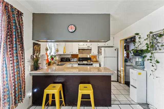 a kitchen with stainless steel appliances granite countertop a sink and a refrigerator
