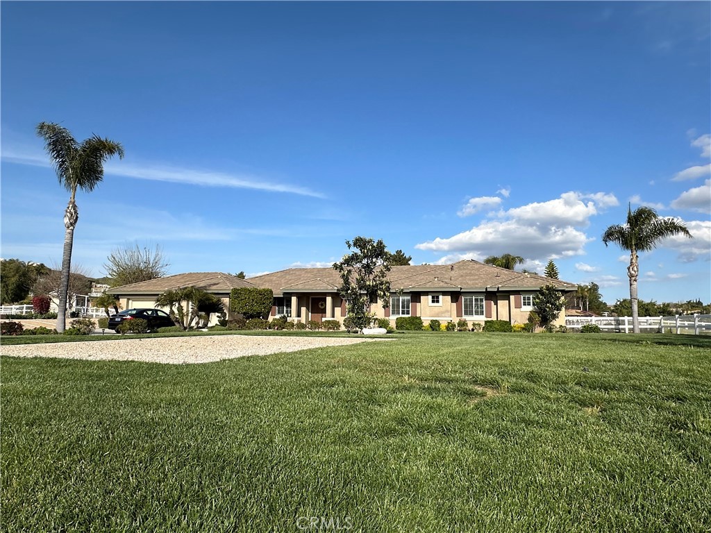 23602 Piedras Road Perris, CA 92570 - Photo 1 of 1 a view of a house with a big yard and potted plants