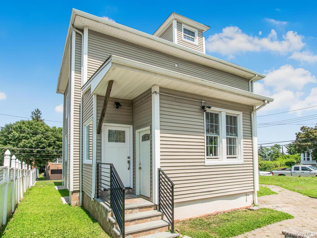 70 Normandy Road Yonkers, NY 10701 - Photo 5 of 26 Light tan horizontal siding exterior with white trim