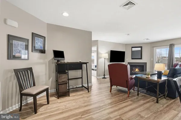 a view of a livingroom with workspace and a couch