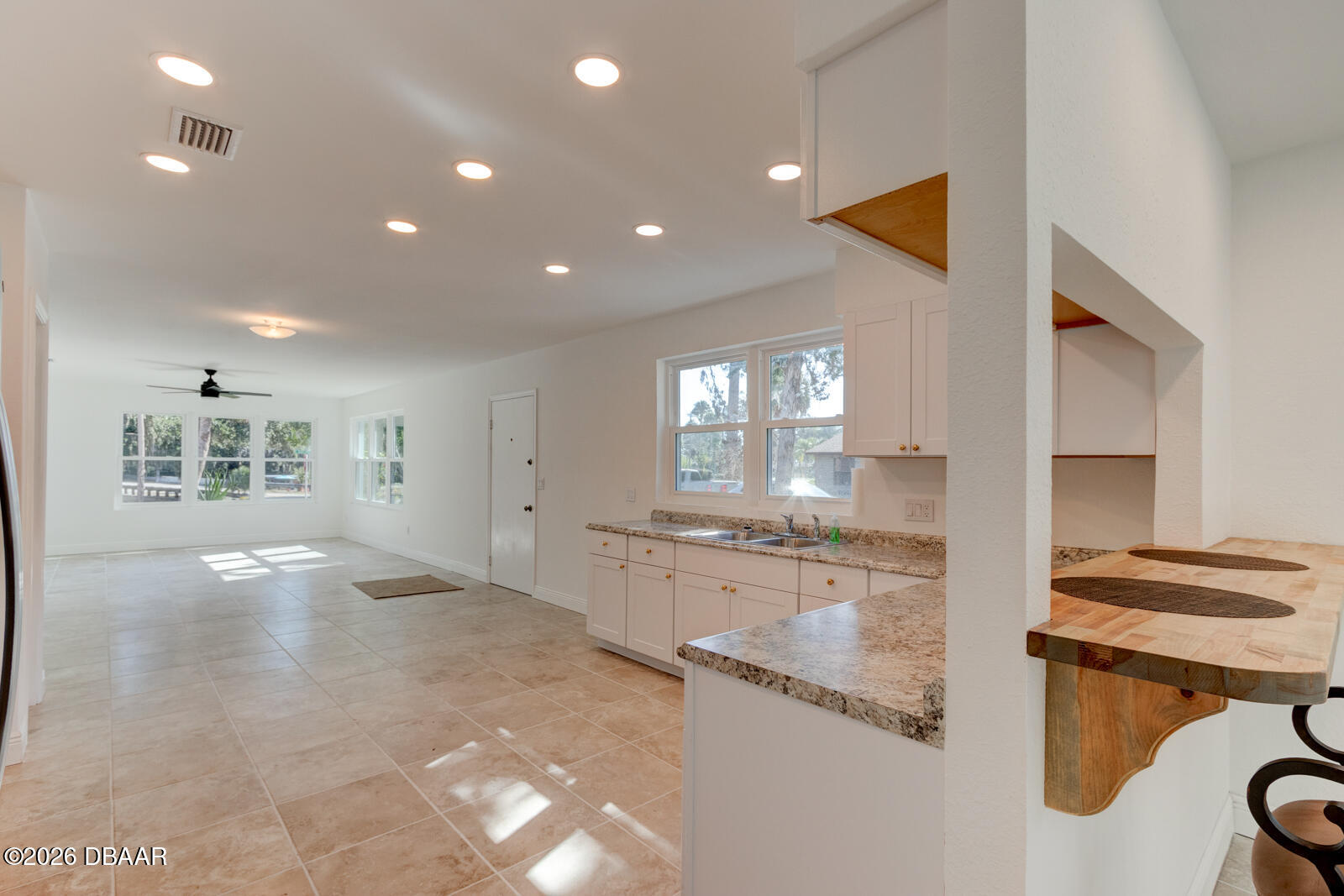 4 Main Street Port Orange, FL 32127 - Photo 4 of 17 a large kitchen with kitchen island a sink stainless steel appliances and cabinets
