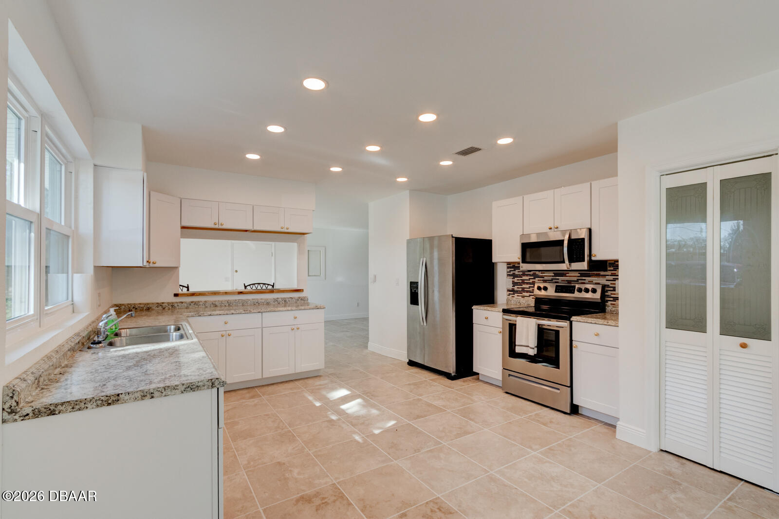 4 Main Street Port Orange, FL 32127 - Photo 5 of 17 a kitchen with stainless steel appliances granite countertop a sink stove oven and refrigerator