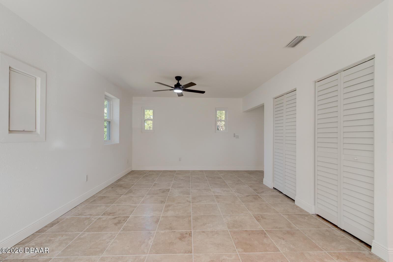4 Main Street Port Orange, FL 32127 - Photo 9 of 17 a view of an empty room with window and chandelier fan